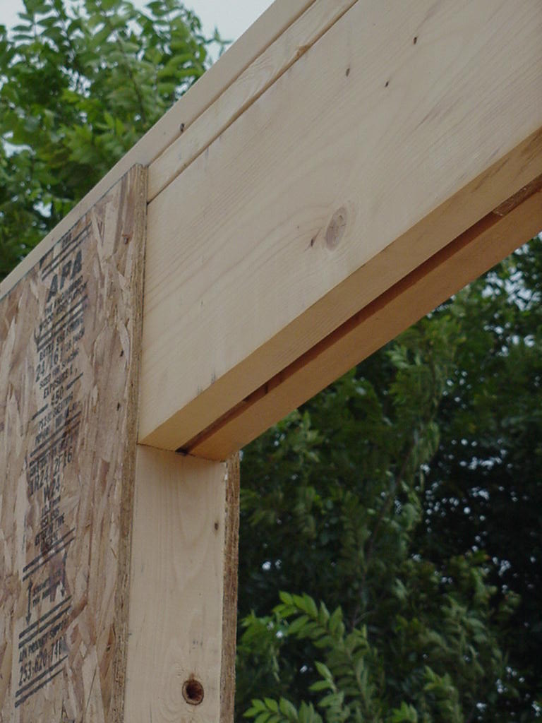 Conventional header rests on jack stud, transferring load. The jack